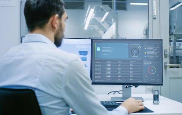 Operator reviewing machine status at workstation